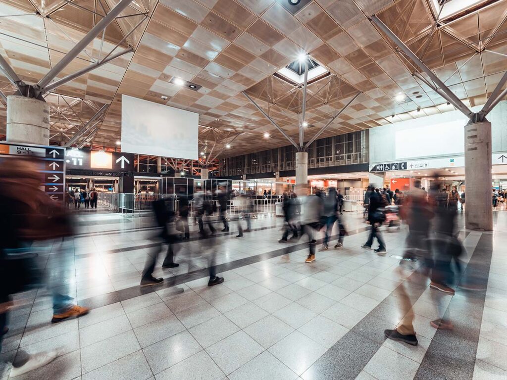 Motion blur of people walking in public mall.